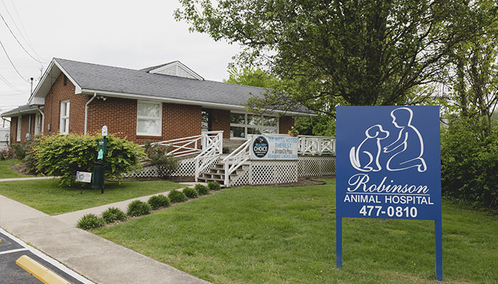 Brick building with a sign for Robinson Animal Hospital and a dog and cat logo.